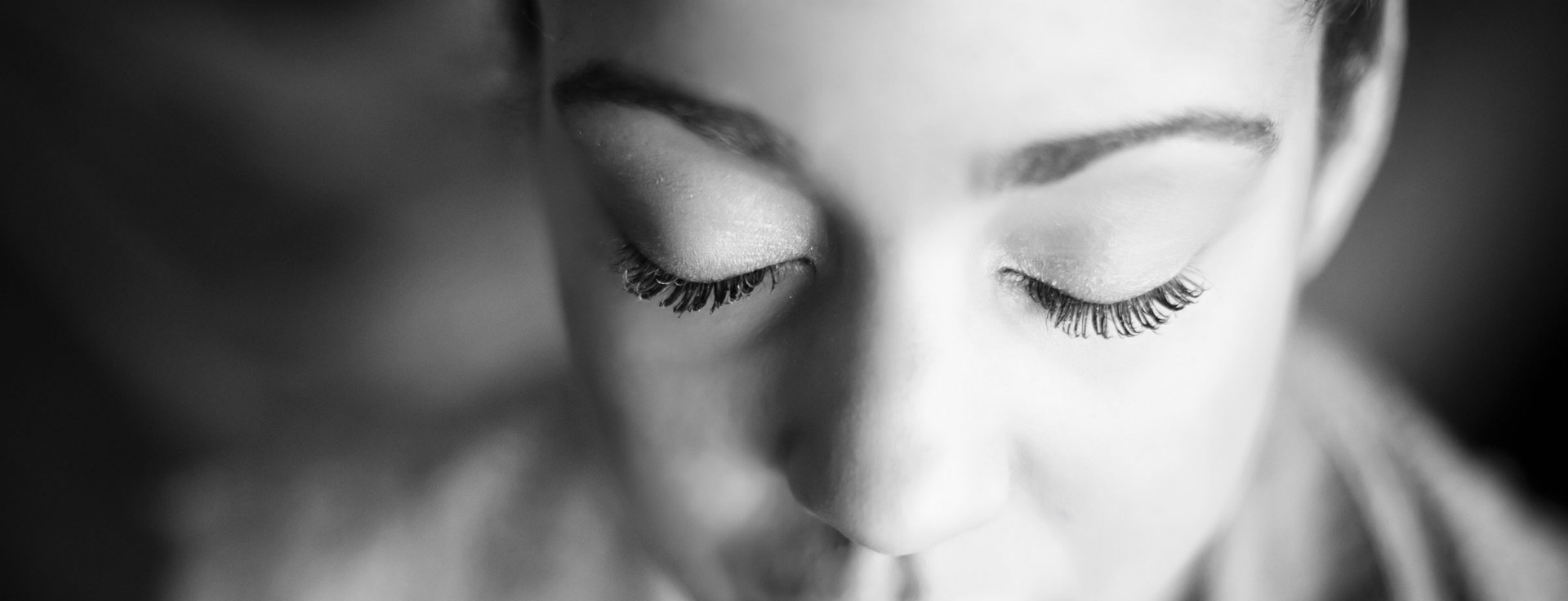 Black-and-white close-up of a person with eyes closed in meditation